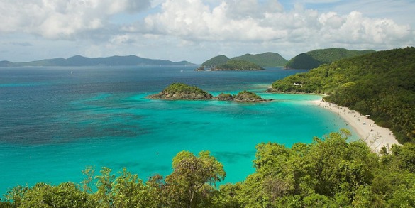 a blue water with islands in the background with Virgin Islands National Park in the background