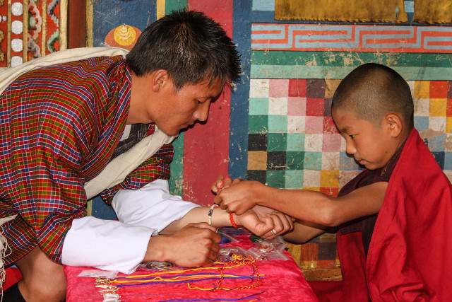 Novice monk and local in national dress